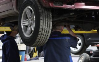 technicians working under a car