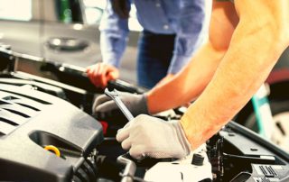 mechanic working on a car with a wrench