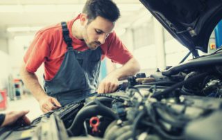 male technician working on a car