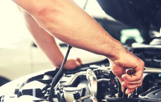 mechanic working on a car with a wrench