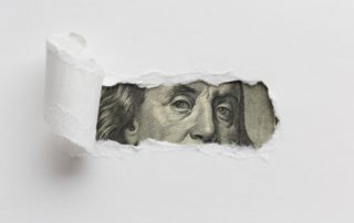ripped paper revealing cash