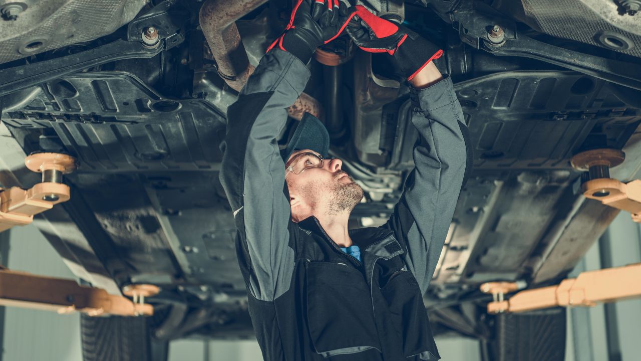Technician working under a car